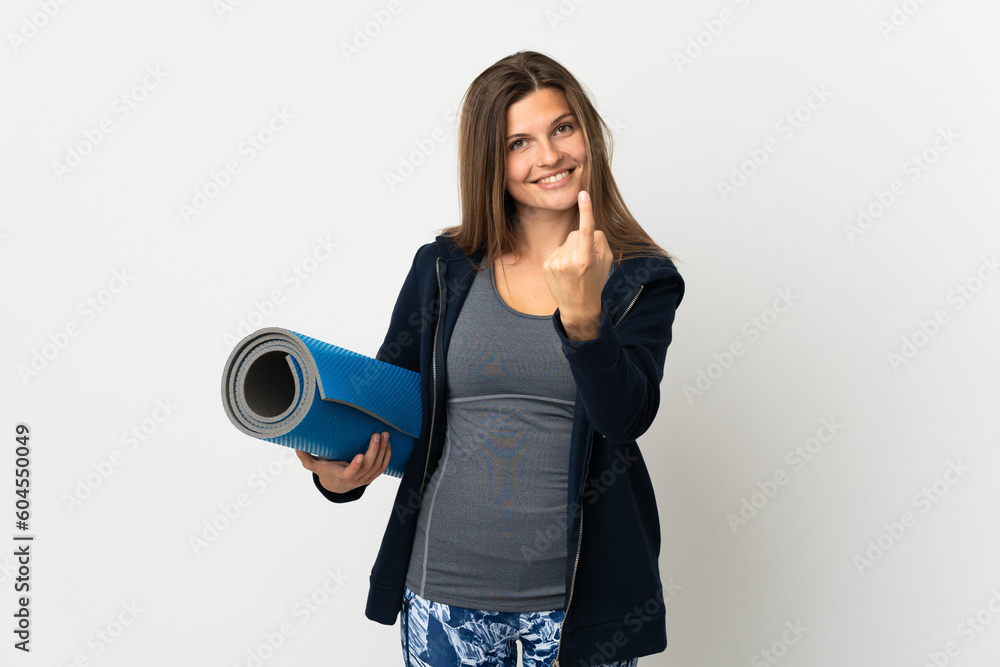 Slovak girl going to yoga classes isolated on white background doing coming gesture Slovak girl going to yoga classes isolated on white background doing coming gesture