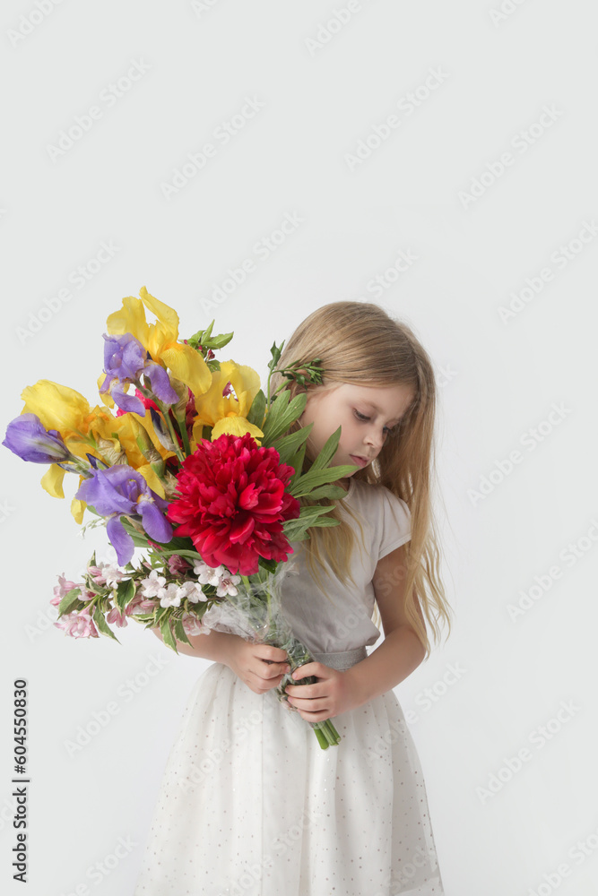 Studio portrait of beautiful little girl holding big colorful bouquet of various flowers. Studio portrait of beautiful little girl holding big colorful bouquet of various flowers.