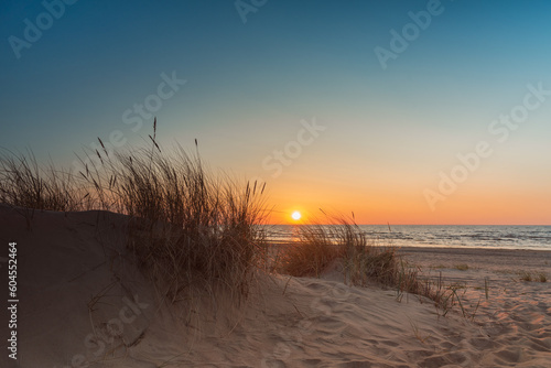 Sunset at Baltic sea beach in Latvia photo