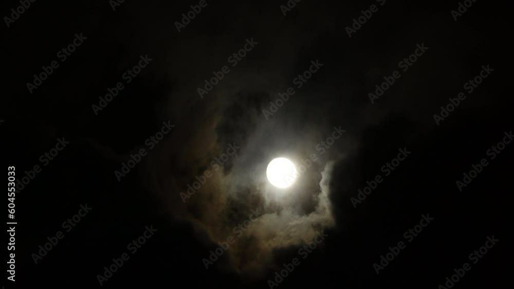 Full moon with storm clouds in the night sky Full moon with storm clouds in the night sky
