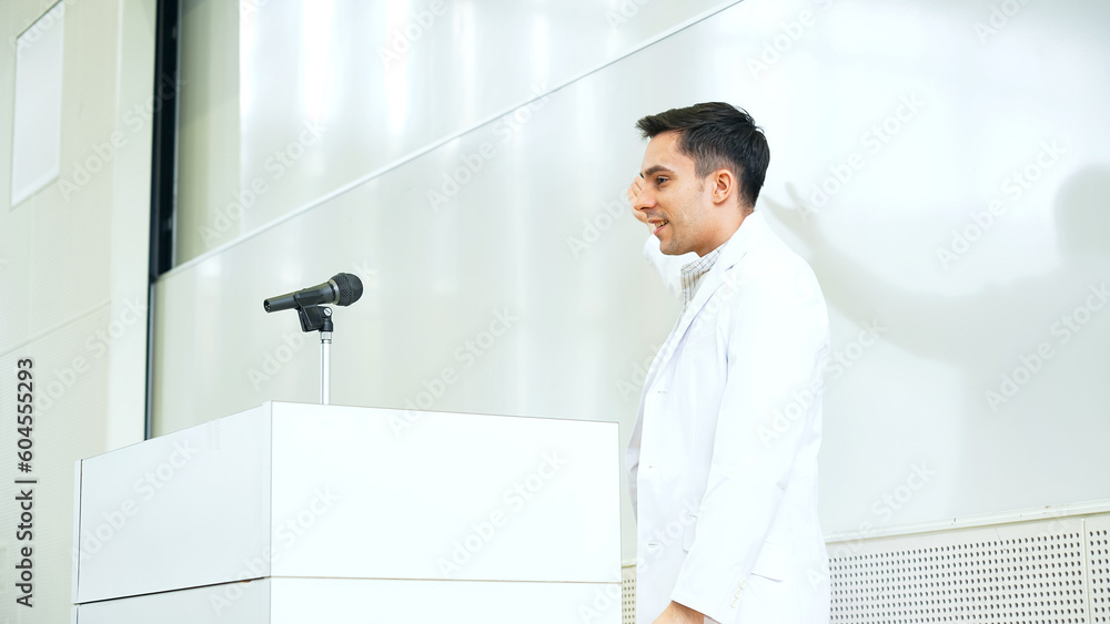Male lecturer giving a lecture in the auditorium. University professor. Science student. Male lecturer giving a lecture in the auditorium. University professor. Science student.