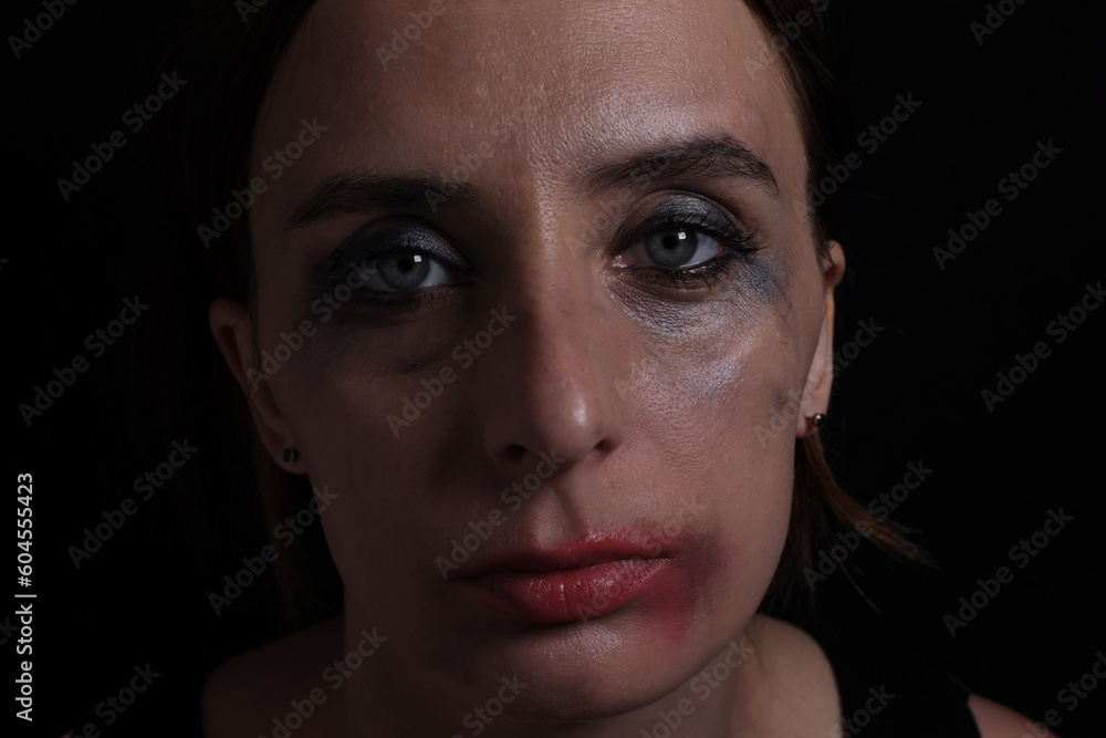 portrait of crying girl with smeared mascara makeup on black background portrait of crying girl with smeared mascara makeup on black background