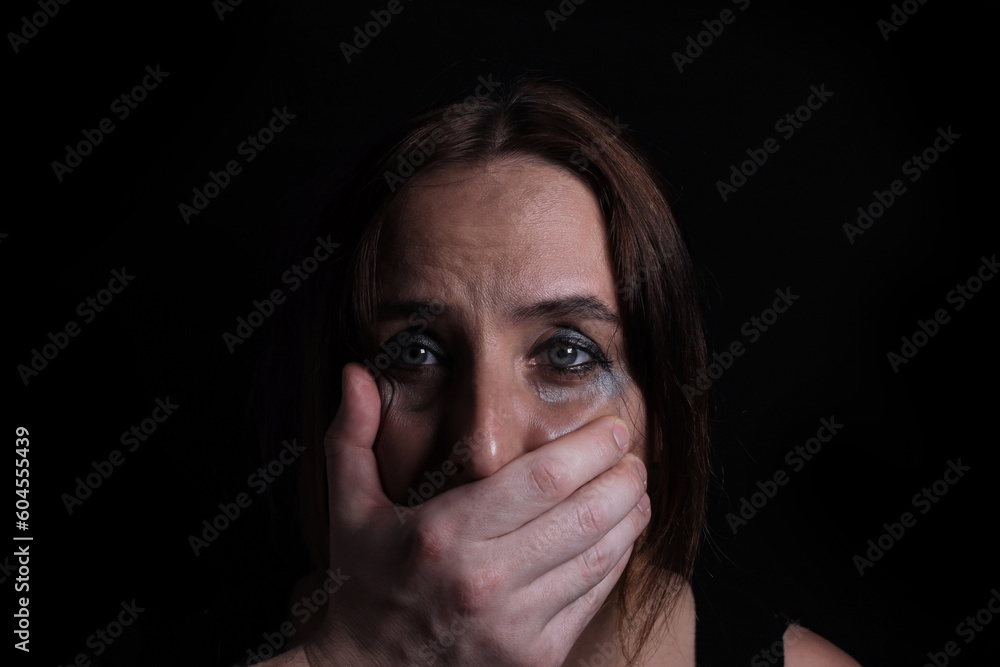 Young crying woman hand closed her mouth the concept of violence, freedom of speech Young crying woman hand closed her mouth the concept of violence, freedom of speech