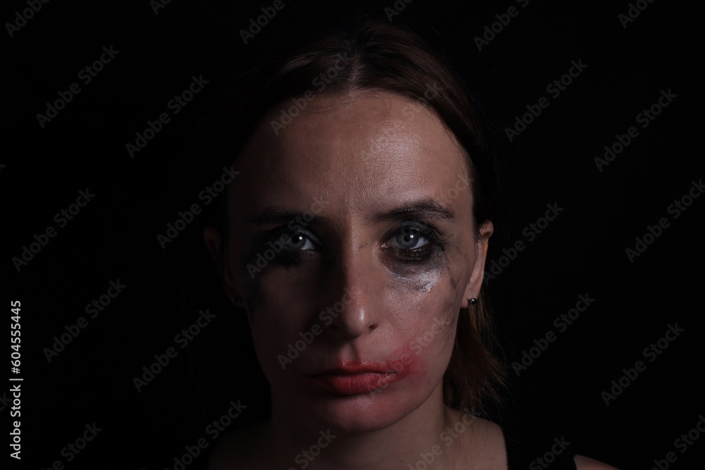 Fototapeta premium Portrait of an upset crying woman, the concept of mourning, violence