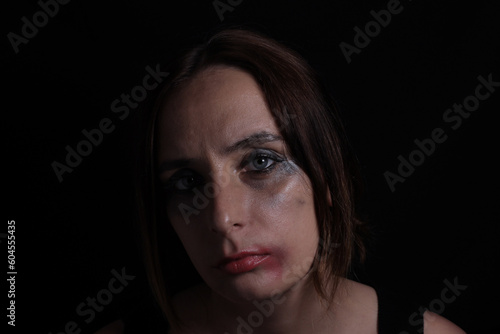 portrait of crying girl with smeared mascara makeup on black background