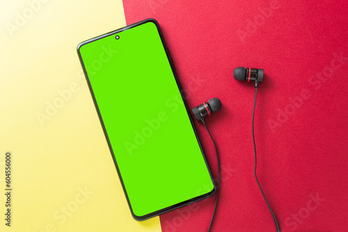 Big wireless headphones and phone. Chromakey space on the phone screen