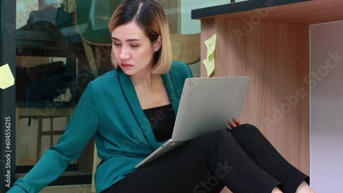 Busy working and overtime work. businesswoman busy angey mad and serious looking at data on paper and throwing papers at home office photo