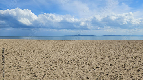 Beautiful Sea coast, deserted sandy beach and white clouds