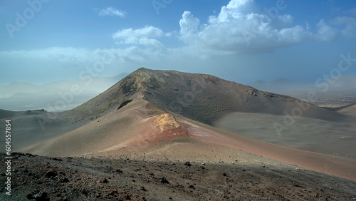 View of volcanic landscape in Valle del Silencio, Valley of Silence in Timanfaya National Park in Lanzarote, Canary Islands, Spain