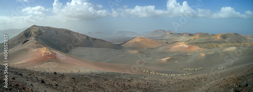 View of volcanic landscape in Valle del Silencio, Valley of Silence in Timanfaya National Park in Lanzarote, Canary Islands, Spain