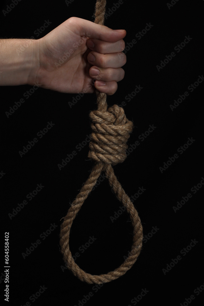 Rope noose of lynch for hanging in hand on black background Rope noose of lynch for hanging in hand on black background