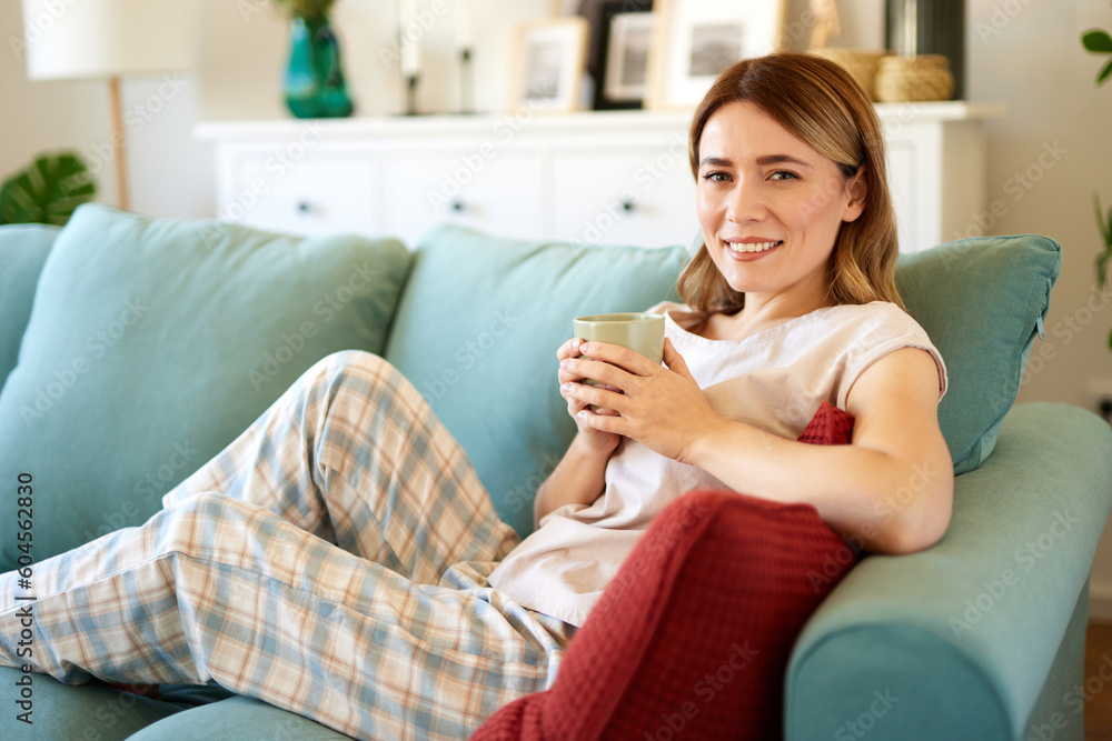 An attractive young woman relaxing at home drinking coffee An attractive young woman relaxing at home drinking coffee