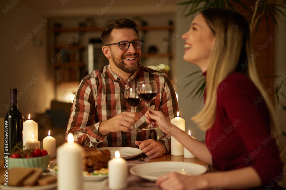 Beautiful couple having romantic dinner with candles and red wine at home Beautiful couple having romantic dinner with candles and red wine at home
