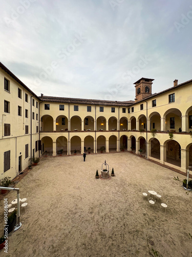 Fototapeta Naklejka Na Ścianę i Meble -  inner courtyard of ancient monastery with tables. Parma area, Italy