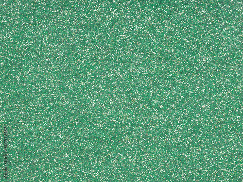 Festive soft green, jade holographic glitter texture. Design pattern of sparkling shiny glitter.