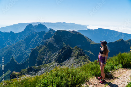 Beautiful tuorist woman stay on point of the island Madeira. View from Pico Ruivo in Madeira the highest in Portugal photo