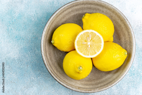 Fresh lemons on bright background. Lemon fruit citrus. Composition with whole, slices of lemons.