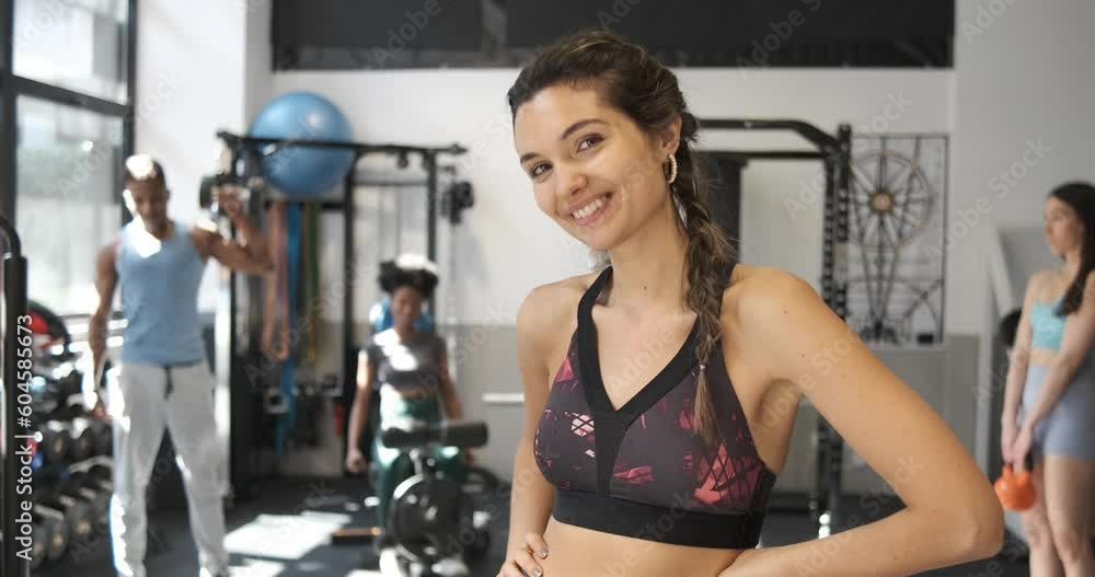 Cheerful woman in sports center showing biceps Cheerful woman in sports center showing biceps