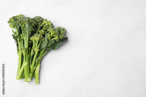 Fresh raw broccolini on white background, flat lay and space for text. Healthy food