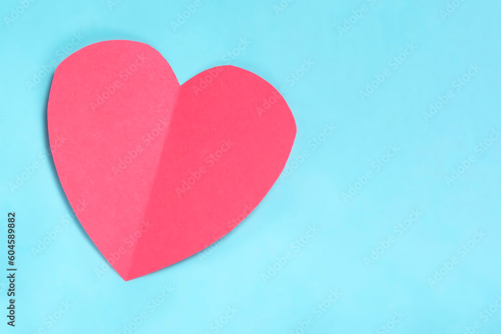 Valentine's day concept. Red paper heart on blue background. Copy space for your text.