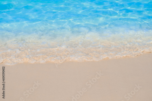 beautiful sandy beach and soft blue ocean wave. summer background concept