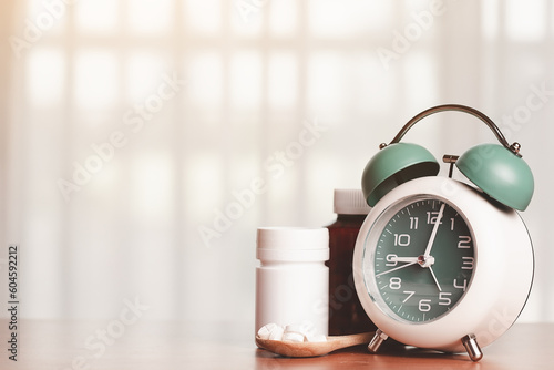 An alarm clock with pills o...