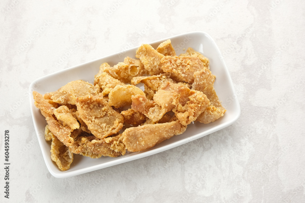 Crispy Fried Chicken Skin (Kulit Ayam Krispi) served on plate
Crispy Fried Chicken Skin (Kulit Ayam Krispi) served on plate