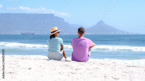 Bloubergstrand Cape Town South Africa on a bright summer day, couple on the beach, men and women chilling on the beach during vacation in Cape Town South Africa photo