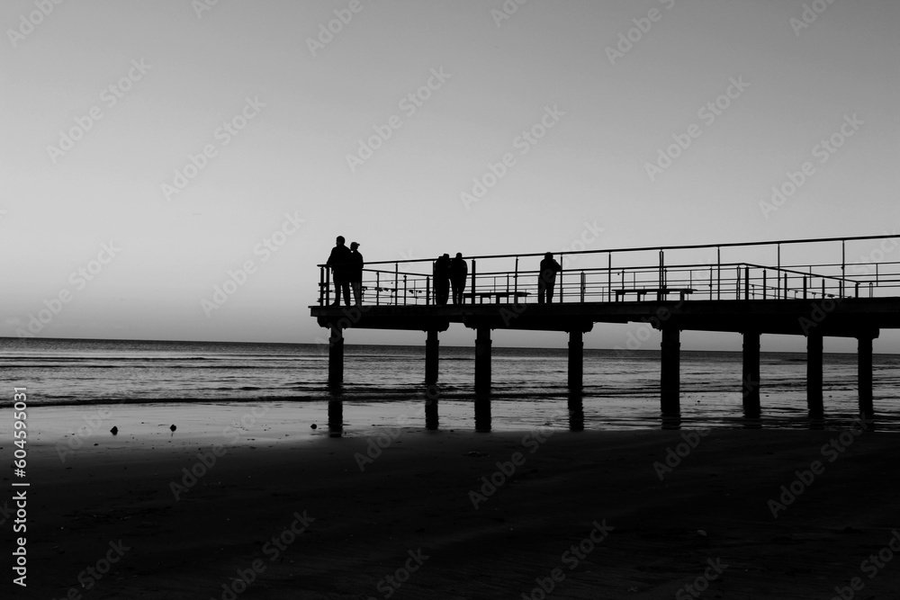 Fototapeta premium People standing on the pier and looking at the sea in Larnaca, Cyprus