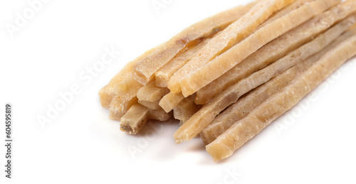 Close-up of dried salted tuna stripes background. Beer snacks, restaurant menu, salty seafood