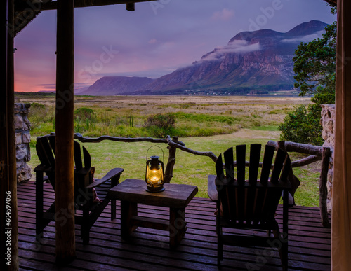 Wallpaper Mural Mountains and grassland near Hermanus at the Garden Route Western Cape South Africa Whale coast. A lodge wooden bungalow with chairs during a vacation in South Africa at Susnet Torontodigital.ca