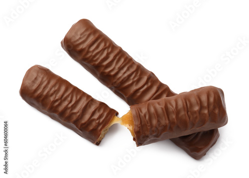 Sweet tasty chocolate bars with caramel on white background, top view