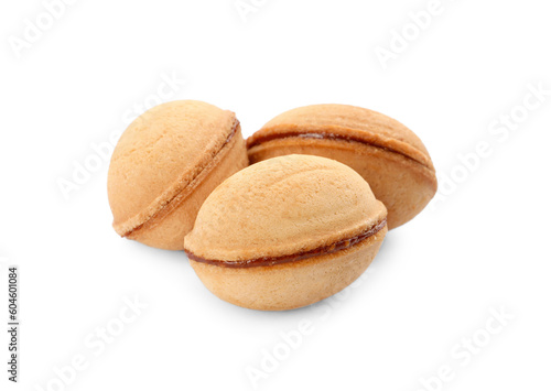 Delicious nut shaped cookies with boiled condensed milk on white background