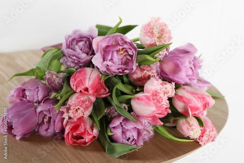 Beautiful bouquet of colorful tulip flowers on wooden table