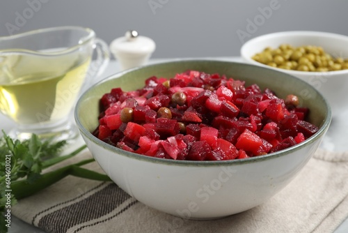 Bowl of delicious fresh vinaigrette salad on table, closeup