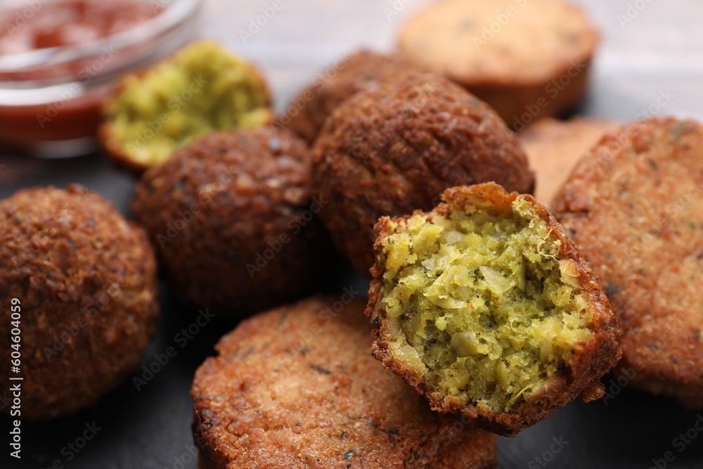 Delicious vegan cutlets and falafel balls on slate board, closeup Delicious vegan cutlets and falafel balls on slate board, closeup