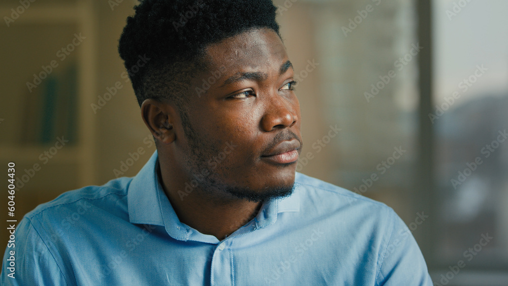 Thoughtful businessman adult ethnic African American man thinking indoors smart pondering executive worker manager specialist think planning dreaming business ideas thoughts brainstorming create plan