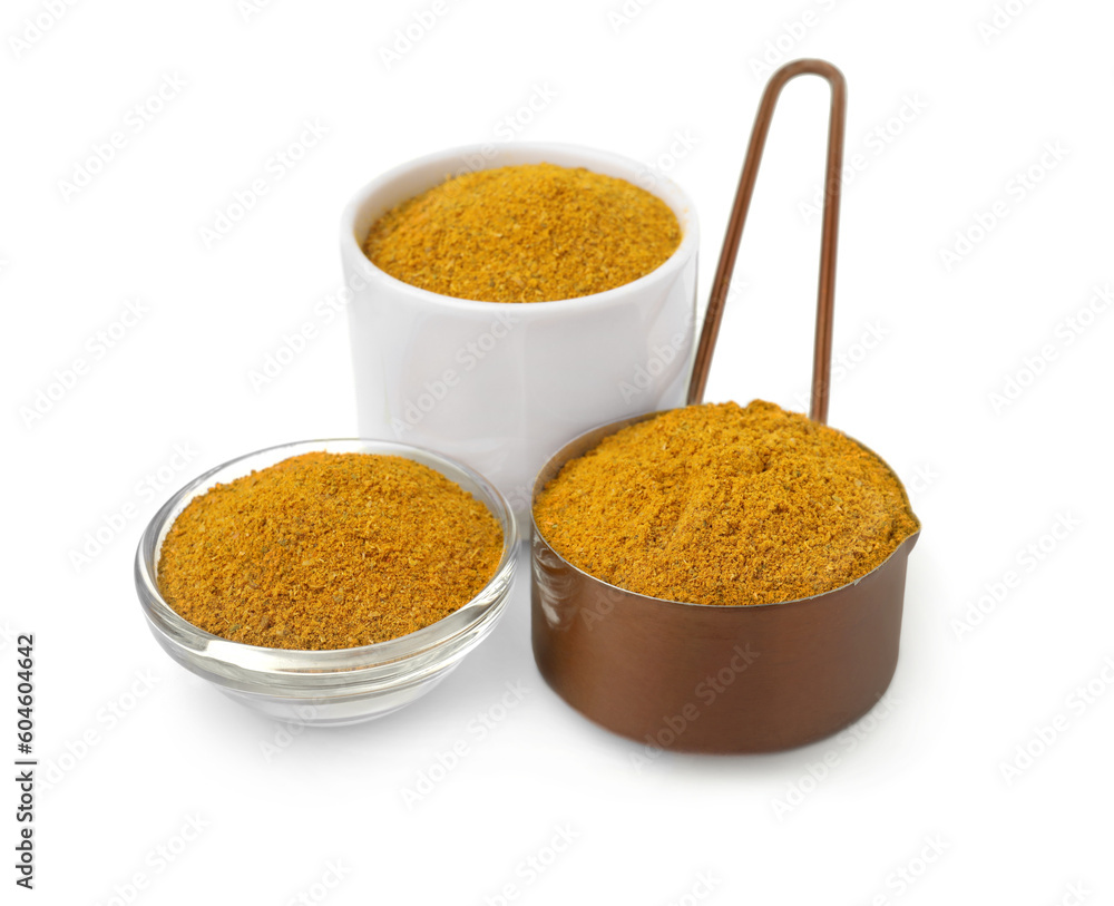 Glass, bowl and scoop with curry powder on white background Glass, bowl and scoop with curry powder on white background