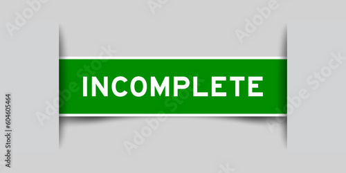 Green color square label sticker with word incomplete that inserted in gray background