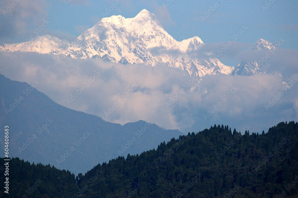 The magnificent view of fog covered Mt. Kangchenjunga, the third highest mountain in the world measuring situate at 8,586 m (28,169 ft) as seen from Gangtok, Sikkim.