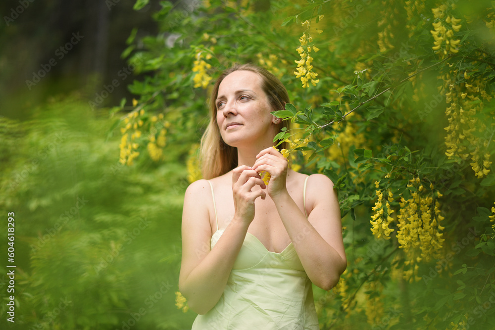 woman with yellow flowers in the park woman with yellow flowers in the park