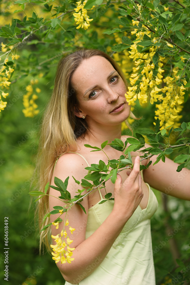 woman with yellow flowers in the park woman with yellow flowers in the park