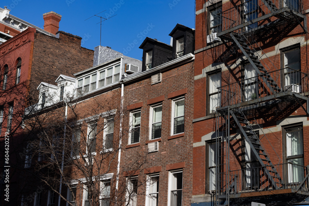 Row of Old Brick Residential Buildings with Fire Escapes in Greenwich Village of New York City