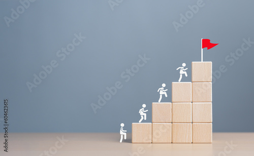 Business goal achievement and objective target for company success. Rises upstairs to Target. Human self-improvement and growth. Human icons climb on ladder stack block to the final goal red flag.