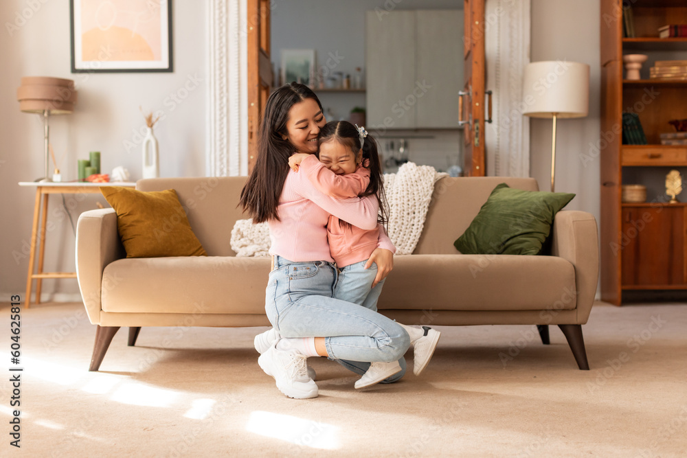 Loving Asian Mom Embracing Adorable Little Baby Daughter At Home Loving Asian Mom Embracing Adorable Little Baby Daughter At Home