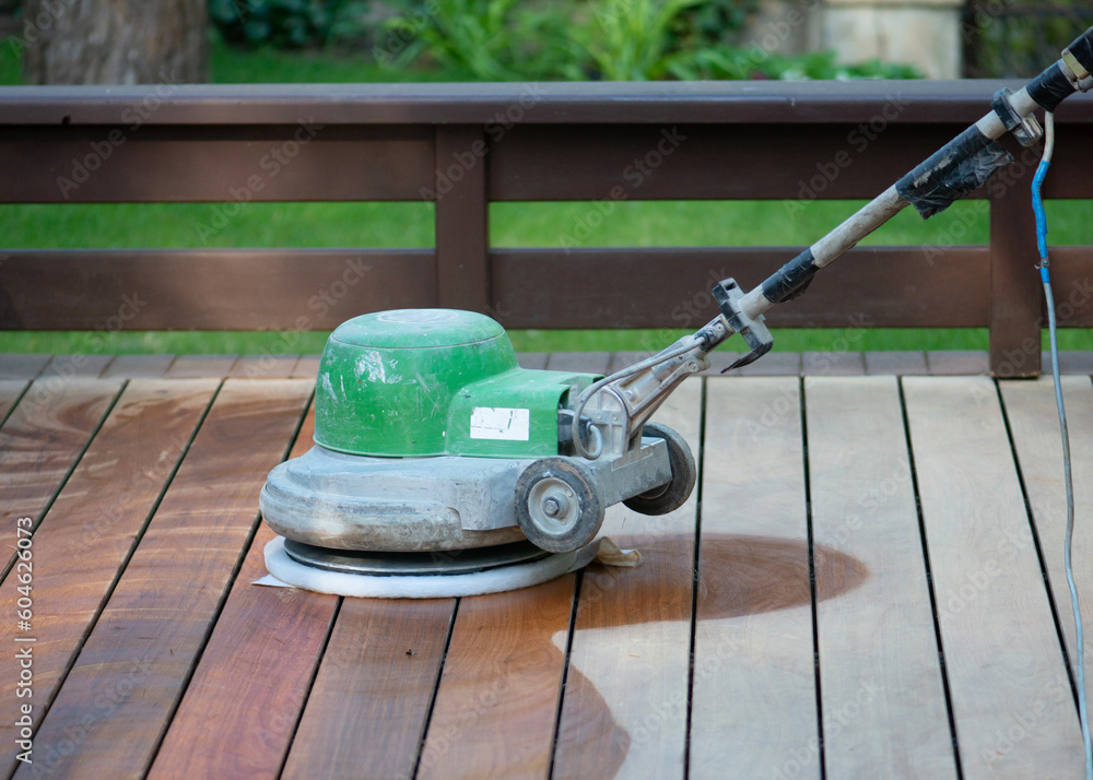 Fototapeta premium Wooden terrace floor restoration. Cleaning dust after sanding.