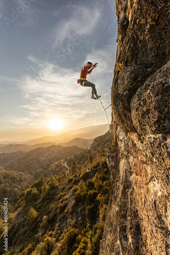 man climbing at sunset on a trip, fearless courageous person, fearless person, extreme sport confidence dramatic sky, sport professional mountain safety, risk of accidents