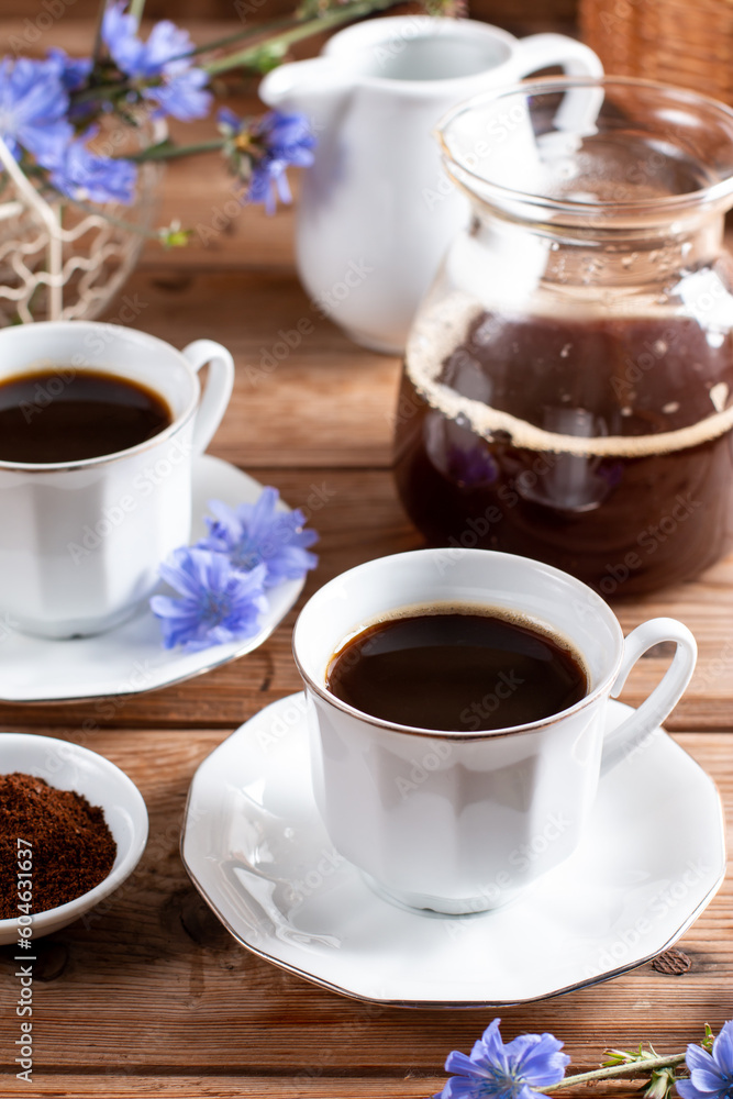 Fototapeta premium Healthy chicory beverage and blue flowers on a table. Coffee substitute.