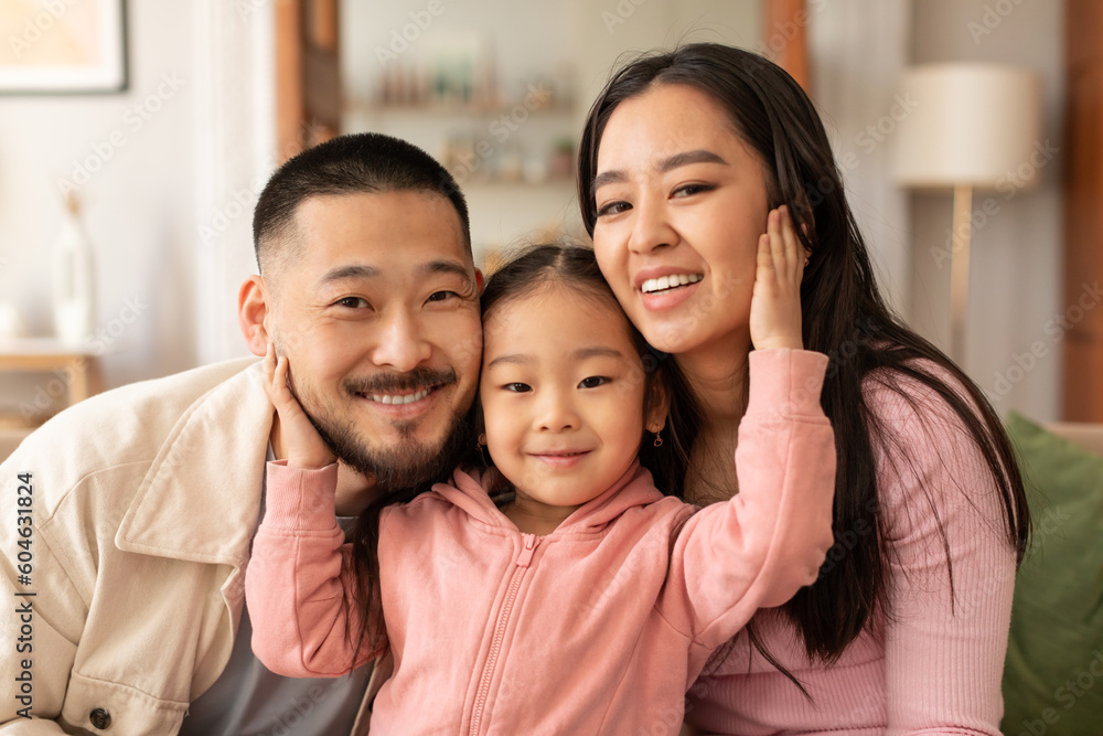 Portrait Of Lovely Korean Family Of Three Embracing At Home Portrait Of Lovely Korean Family Of Three Embracing At Home