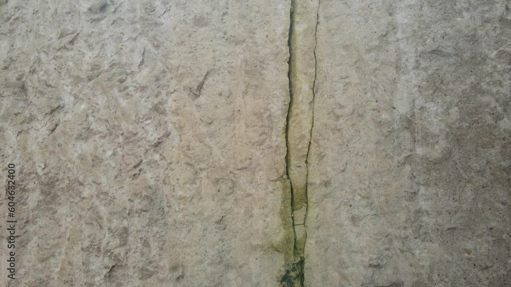 Tracking shooting of crack with deep fault on the rock wall. Earthquake Fault. Close up of a fault line or fracture in the earth in rock Tracking shooting of crack with deep fault on the rock wall. Earthquake Fault. Close up of a fault line or fracture in the earth in rock